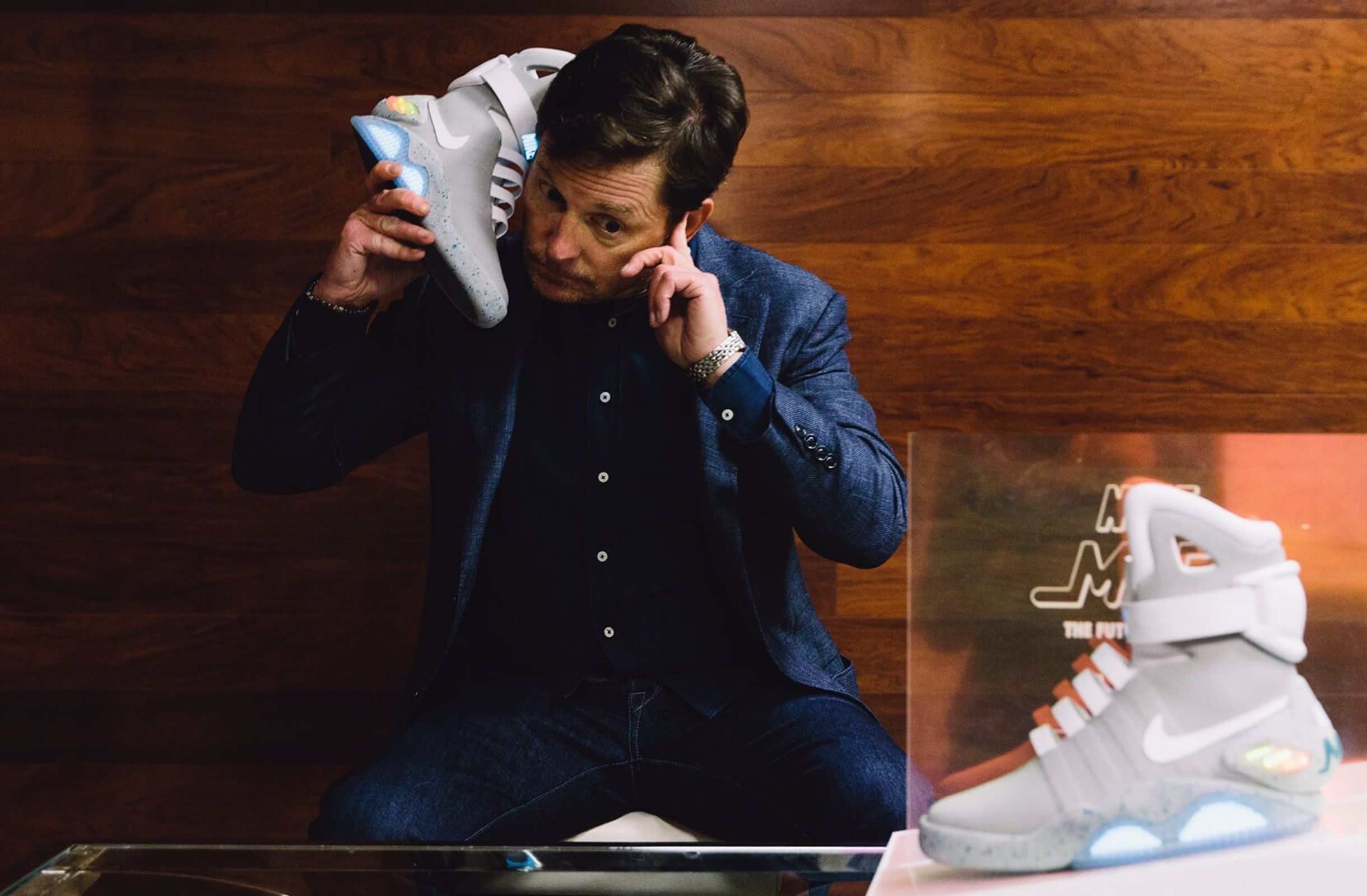 Michael J Fox holding Nike Mag to his ear like telephone