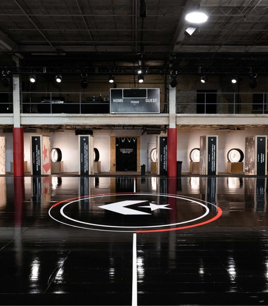 Converse logo center court on black basketball court floor