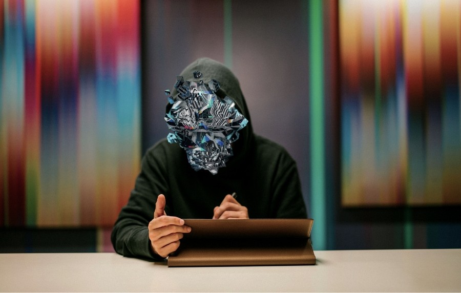 Digital Artist Pantone working on HP computer with digital collage over his face