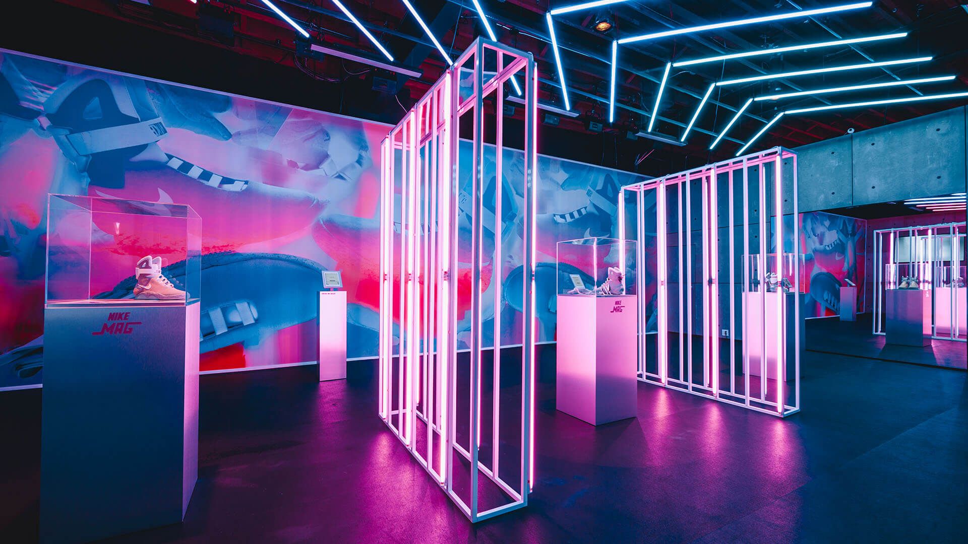 glowing neon walls and ceiling with Nike Mags on podium