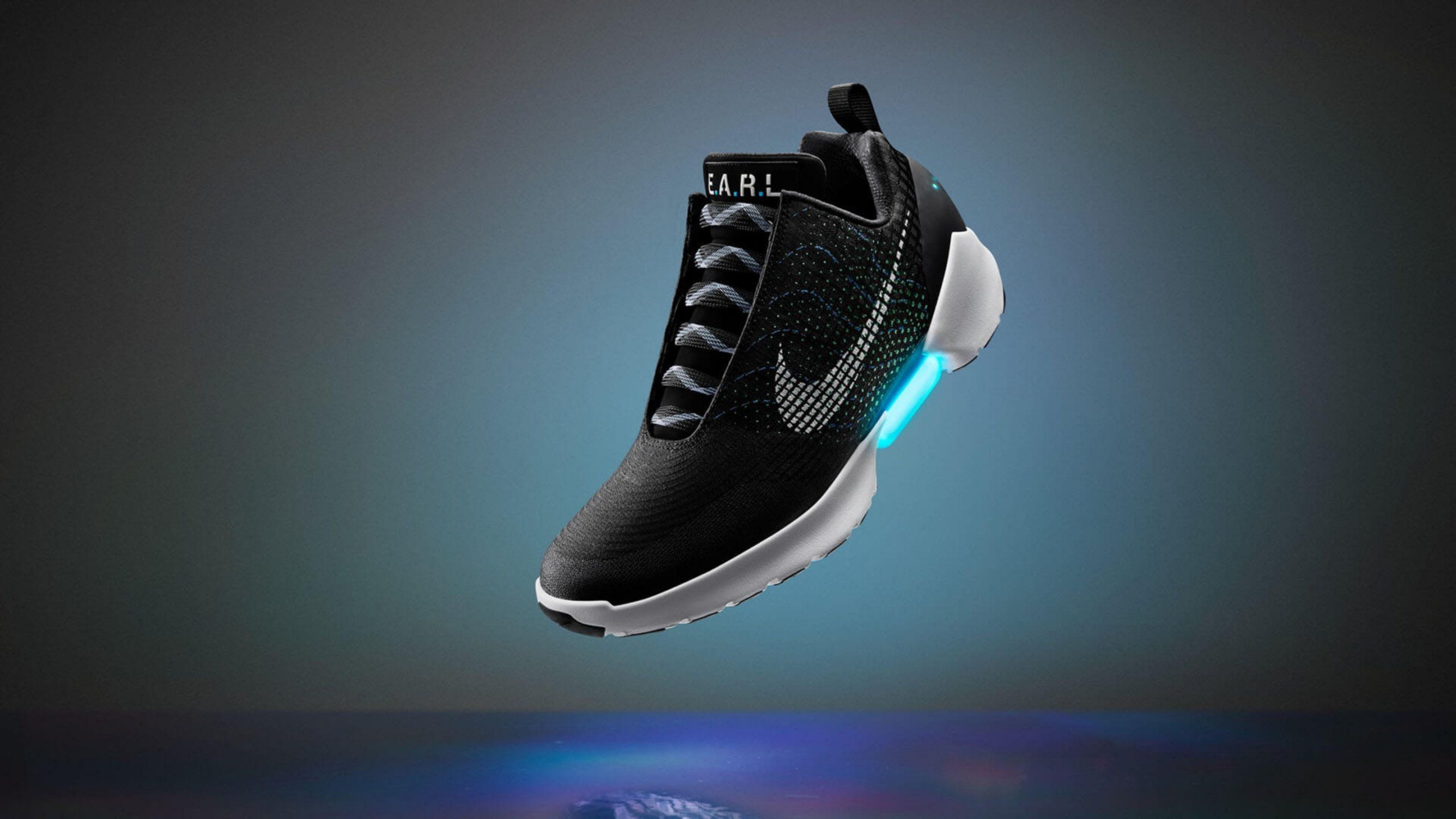 Nike Hyper Adapt in black colorway suspended in air with light up arch