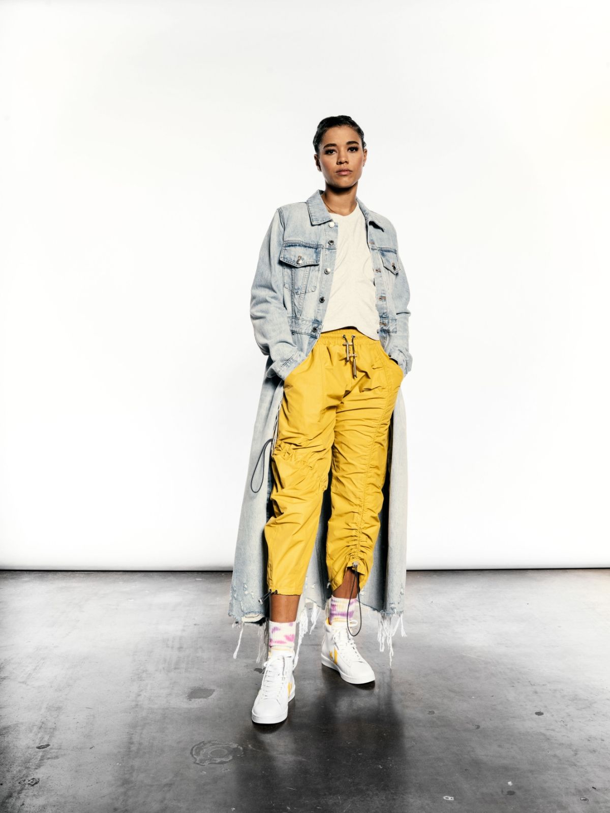 Natasha Clound in Denim overcoat, yellow pants and converse pro leather sneakers