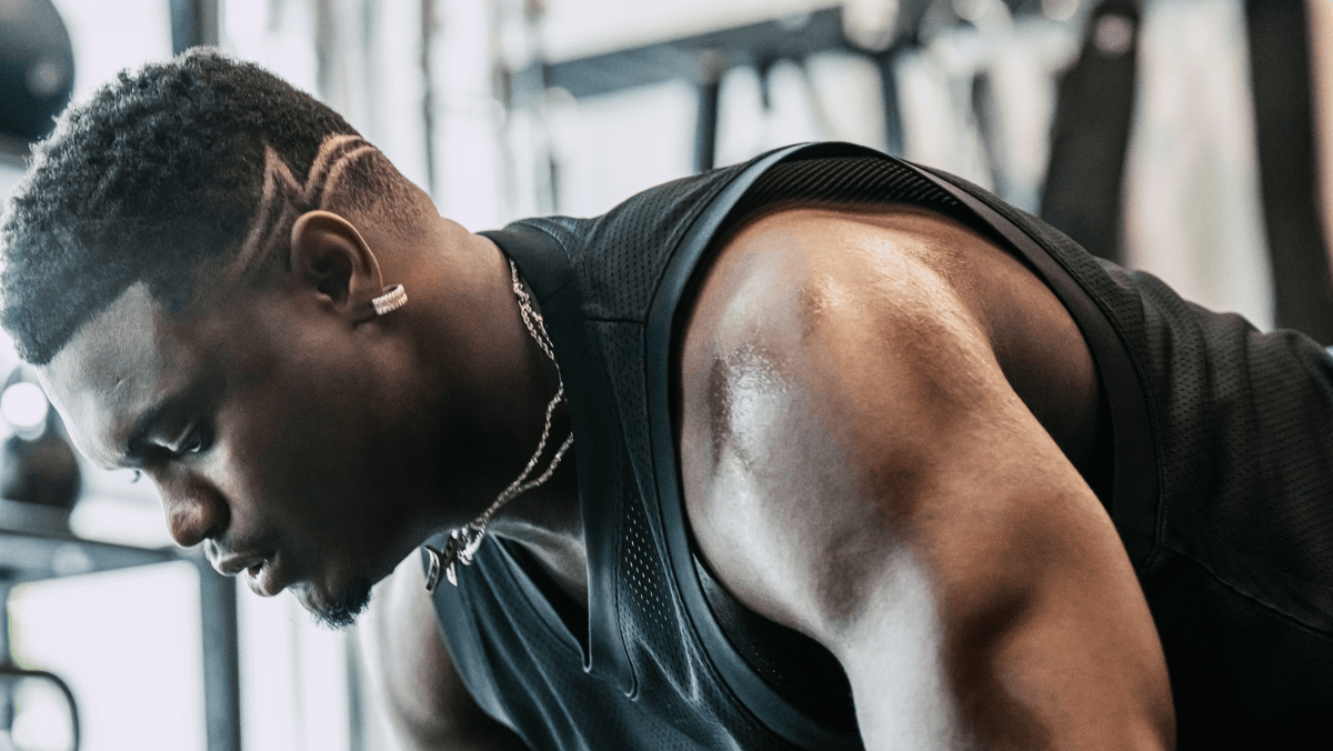 Close up of side view of Zion's face and shoulder as he is working out.