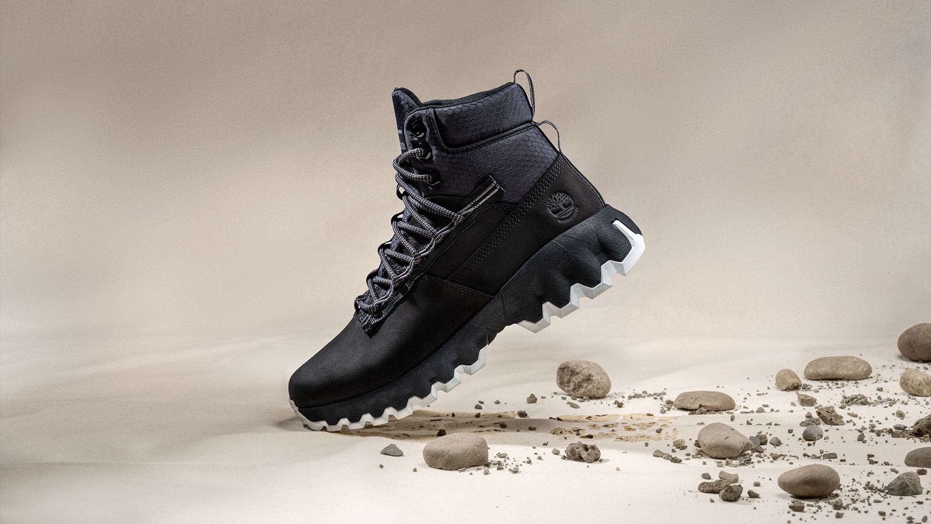 Black Timberland Greenstride Edge boot widht stones and dirt behind it