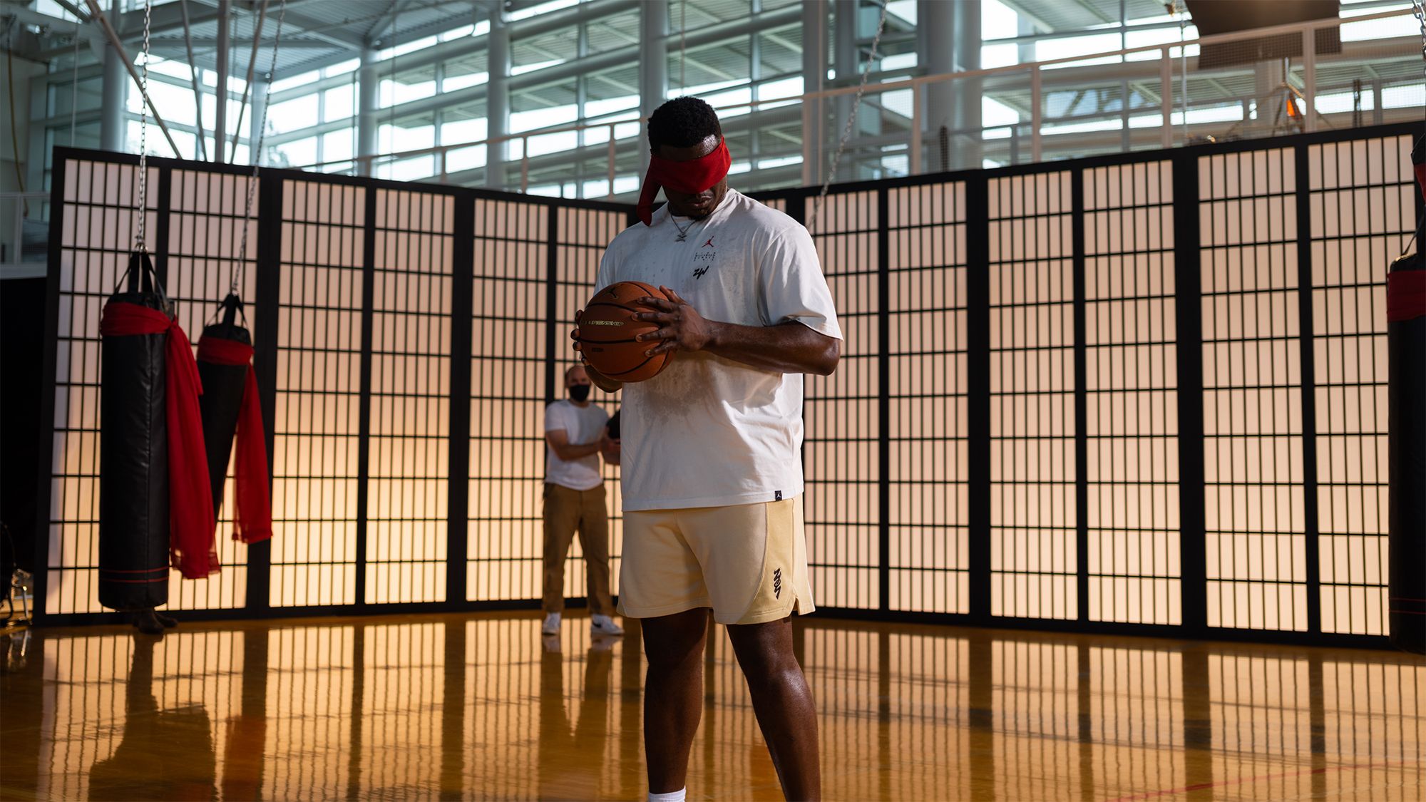 Zion holding basketball with blindfold on