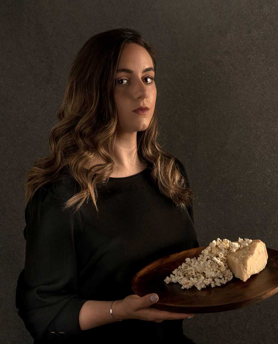 Sofia Villarreal holding plate of popcorn and cheese