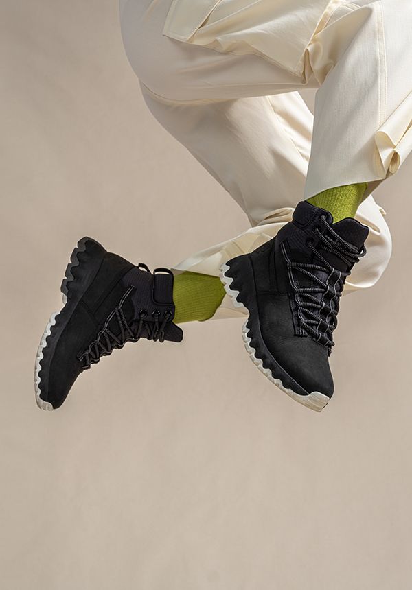 Sophia Li's legs jumping in air showing Timberland Edge Greenstride Boots