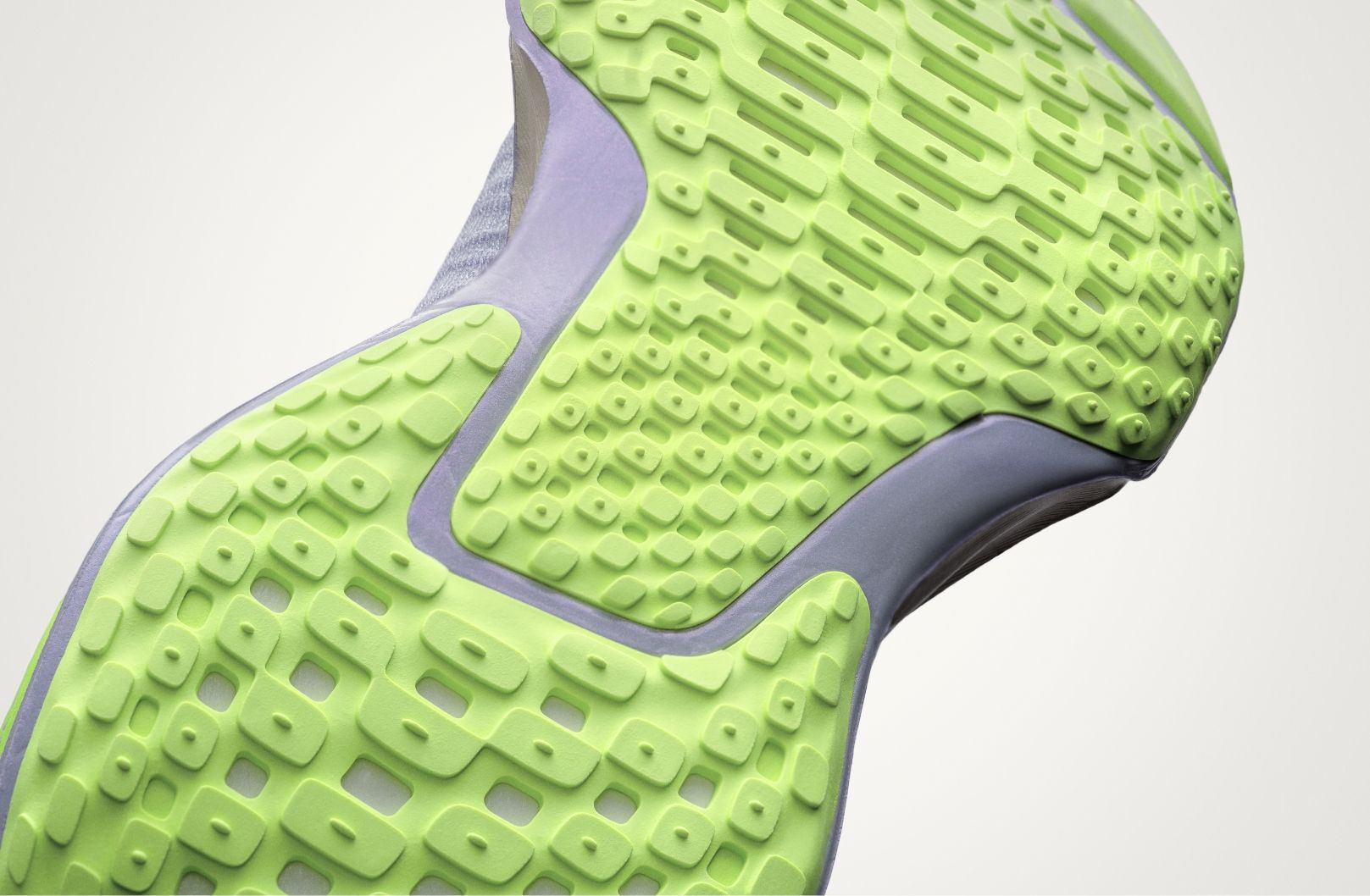 product shot of bottom tread on Nike Invincible 3. It is a bright neon green color.