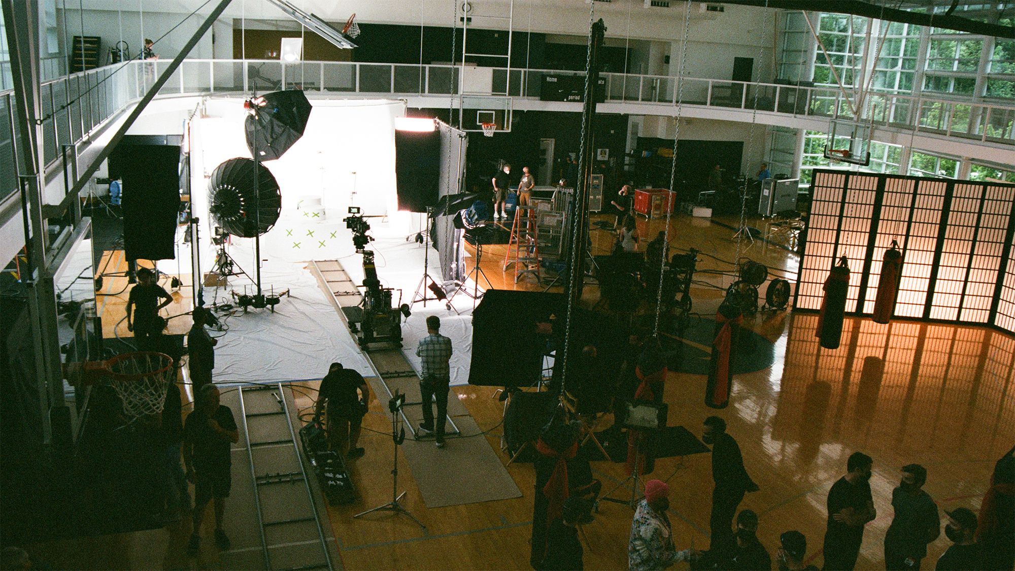 wide shot from above basketball court shoot showing large crew and multiple cameras and lighting
