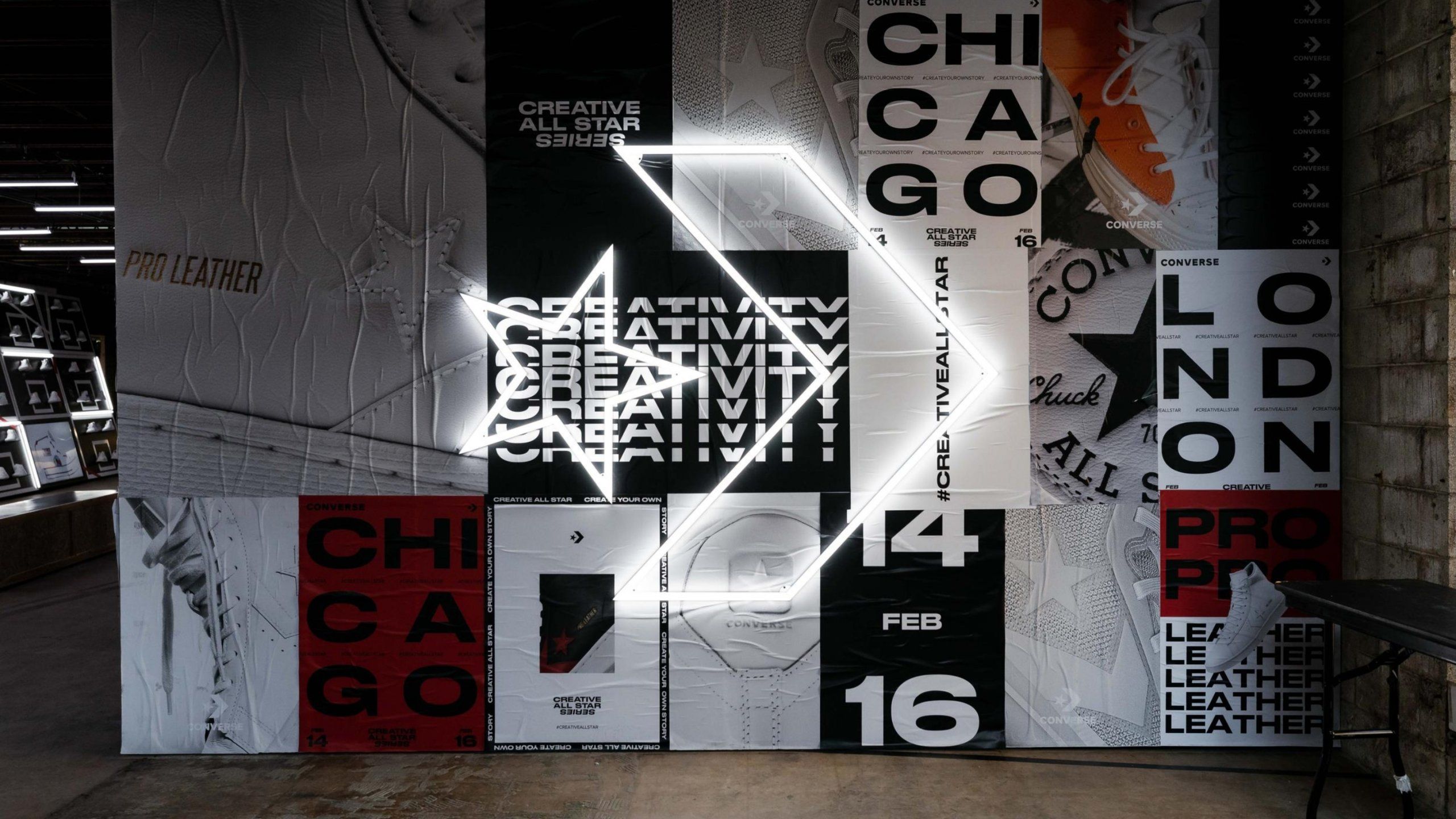 Close up of Converse Event space wall with posters covering wall and neon Converse Logo sign