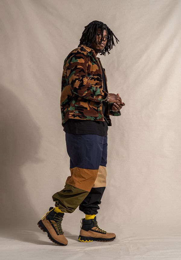 Jon Grey wearing camo jacket and Timberland Greenstride boots