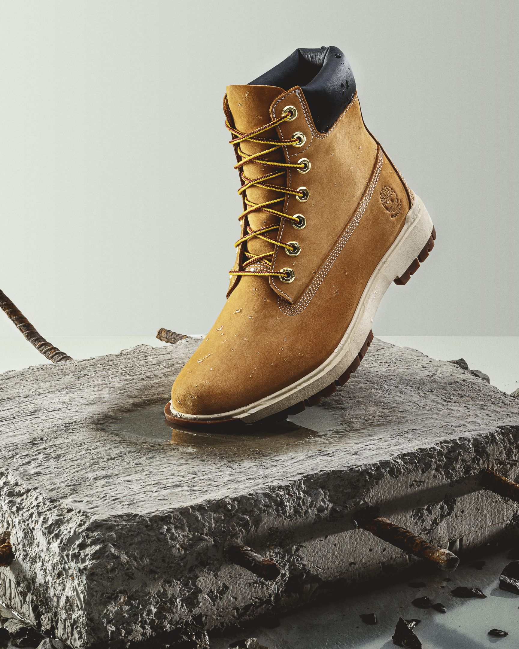 timberland boot on piece of concrete with re-bar