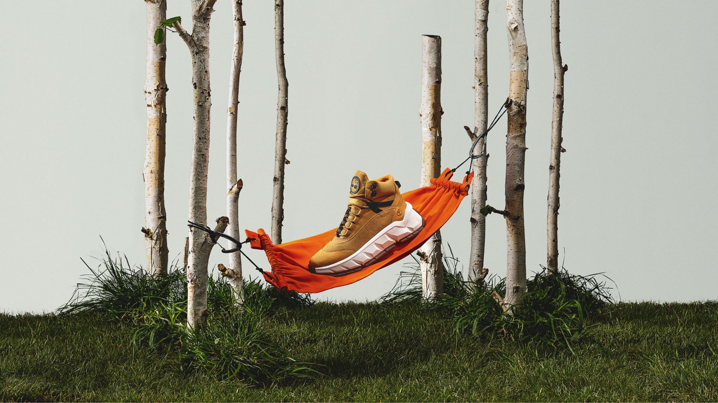 model set up of Timberland boot in small hammock tight to trees with grass below