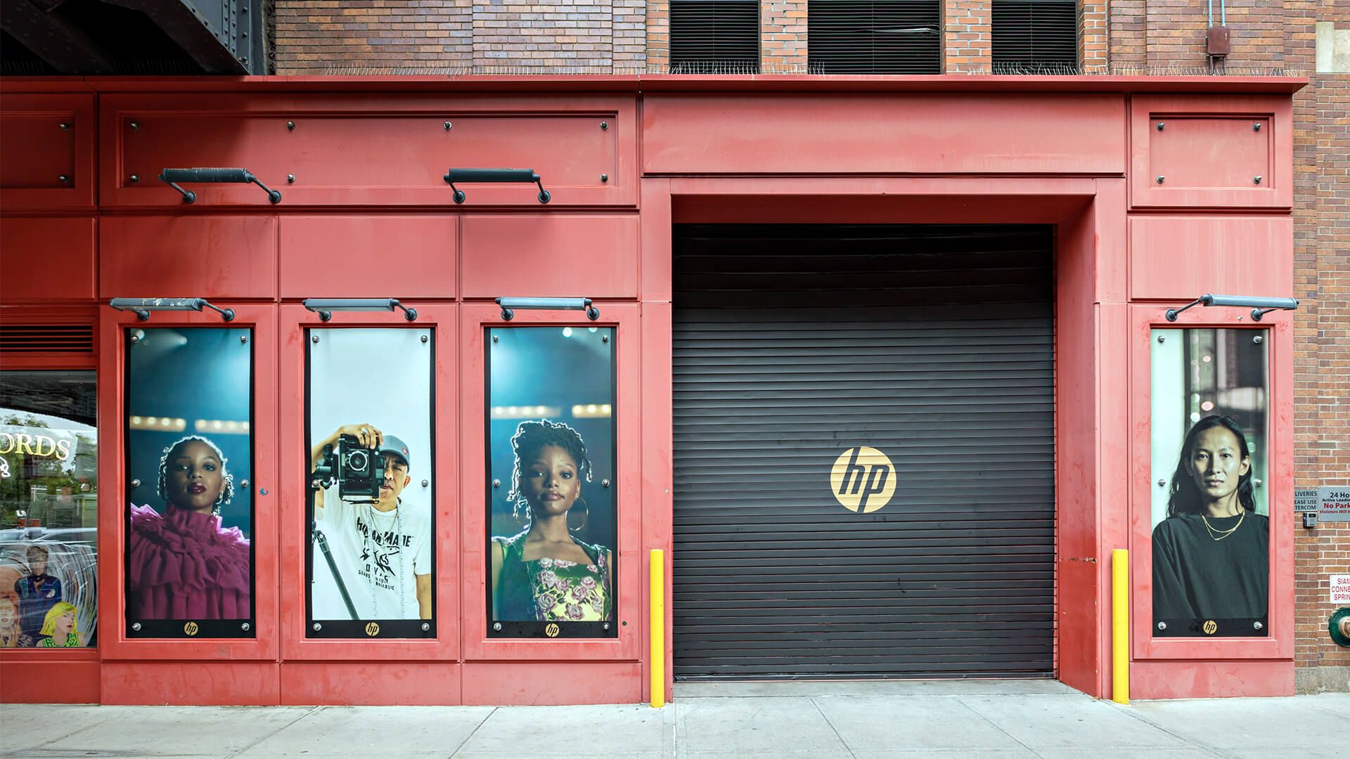 Outside of building for HP launch event in NYC. Posters of artists and garage door with hp logo